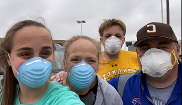 Ginny and her family wearing masks