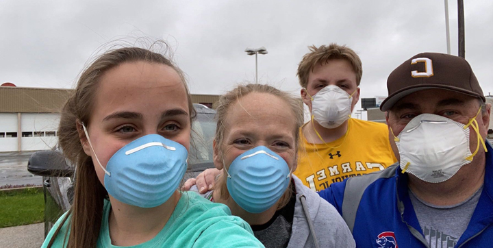 Ginny and her family wearing masks