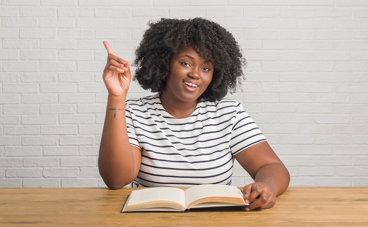 Woman uses her insurance translation guide to understand her benefits.