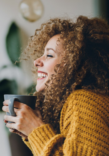 Woman smiles knowing she has voluntary benefits protection for her and her family