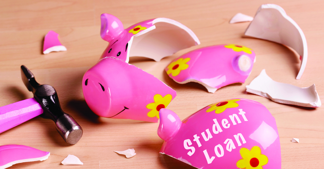 A broken piggy bank with scattered pieces and a hammer beside it.