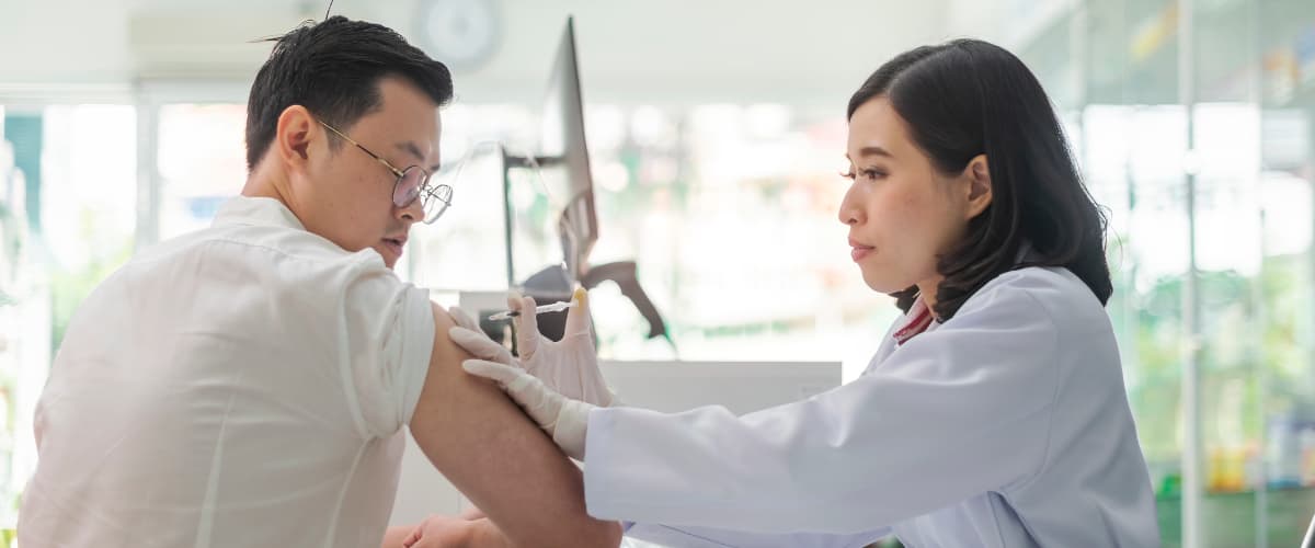 A nurse administering a vaccine to a patient.
